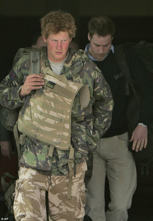 Prince Harry, left, walks with his brother Prince William, right, shortly after returning from active duty in Afghanistan, at Brize Norton Air Force Base in Oxfordshire