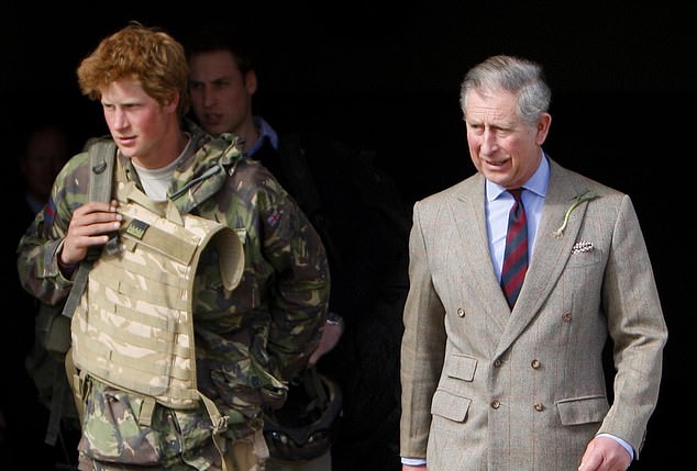 Both his father, Prince Charles, and brother, Prince William - just visible in the background - were in Brize Norton to meet Harry as he returned from active duty