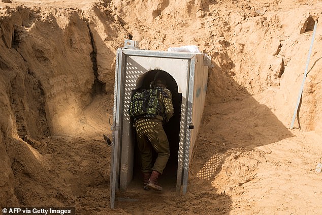 A photo taken on January 18, 2018 from the Israeli side of the Gaza Strip border shows an Israeli army officer walking near the entrance to a tunnel