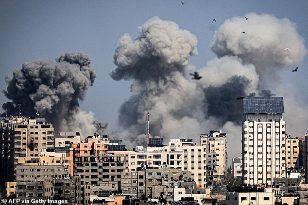 Plumes of smoke rise during Israeli airstrikes in Gaza City on October 12