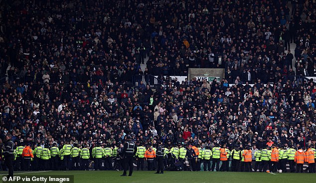 Police line the edge of the pitch after trouble breaks out between fans during the fourth round of the English FA Cup football match between West Bromwich Albion and Wolverhampton Wanderers at Hawthorns Stadium in West Bromwich