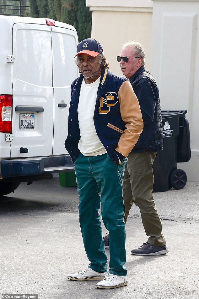 DailyMail.com spotted the crooner looking relaxed as he walked around his adopted home in Los Angeles with a friend