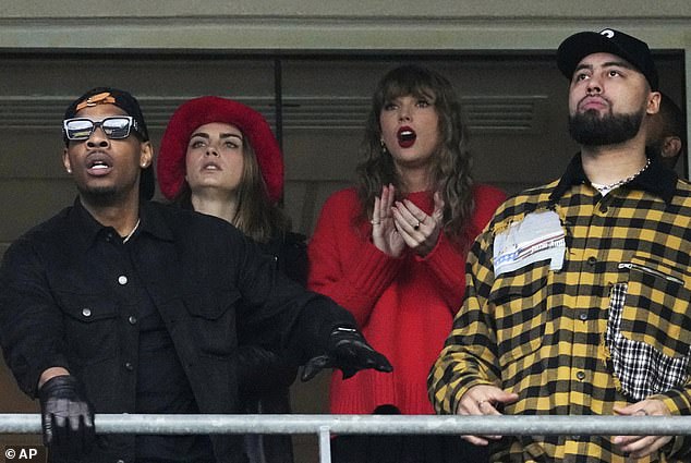 Taylor sat next to her model friend Cara Delevigne and was locked in on the action on the field