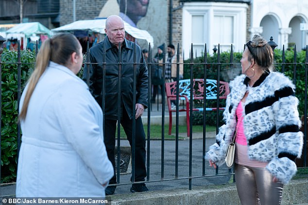 new photos show Karen (Lorraine Stanley, right) walking through Walford as she returns in search of her son Keanu (actress Clair Norris pictured as Bernadette Taylor, left, and Steve McFadden seen as Phil Mitchell, centre)