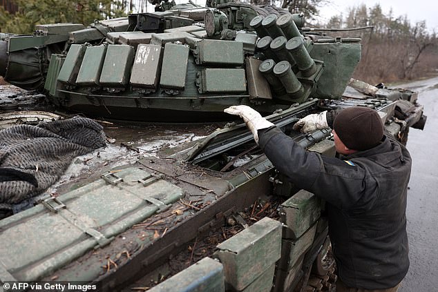 A Ukrainian tank man is seen next to his tank on the road in the Donetsk region on January 27, 2024