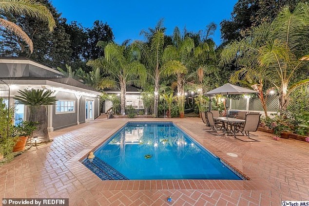 The property's patio and outdoor garden features an in-ground pool and cabana