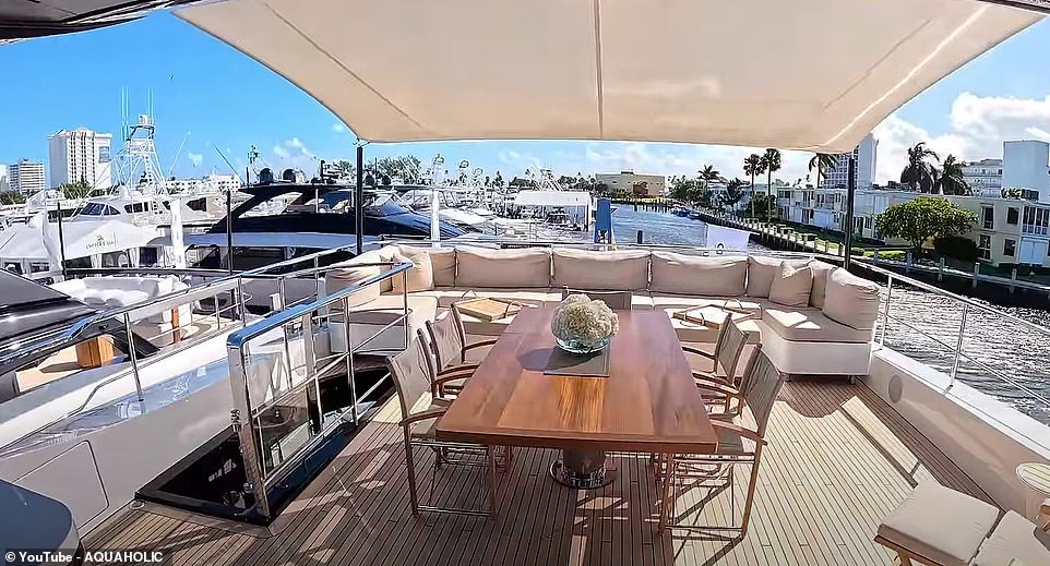 An outdoor area at the rear of the yacht works well as a place for entertaining, with a dining table and benches