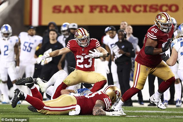 Christian McCaffrey carries the ball during the fourth quarter of their win over the Lions