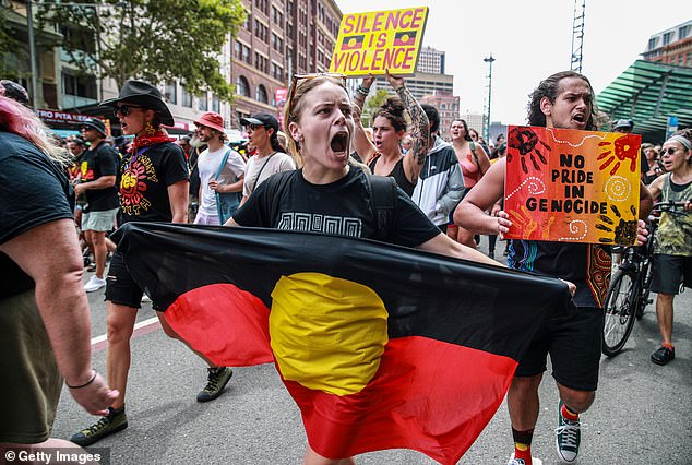 Human rights organization Amnesty International advises against calling someone an Aboriginal on its website, even if they are Aboriginal.  'Invasion Day' protesters are pictured in Sydney on January 26