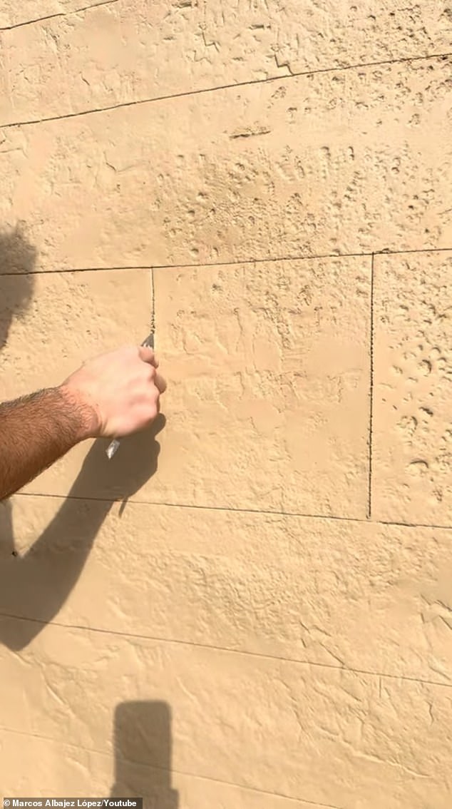 He then used a trowel to outline the edges of the individual faux bricks into the concrete