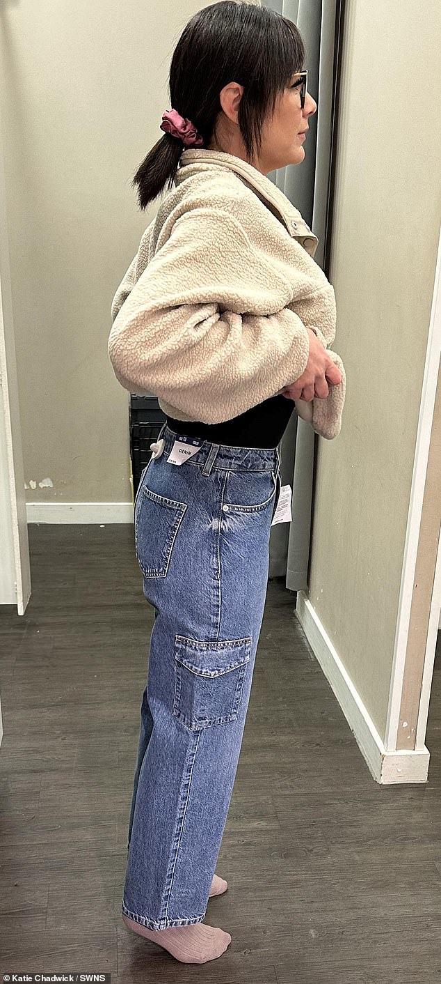 The mother of two claims she can now fit into 13 to 14 year old clothes due to staggering weight loss (photo trying on clothes from children's section)