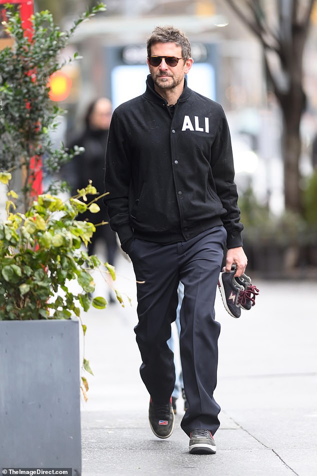 The star wore his hair in spikes and accessorized with stylish shades as he strolled down the street