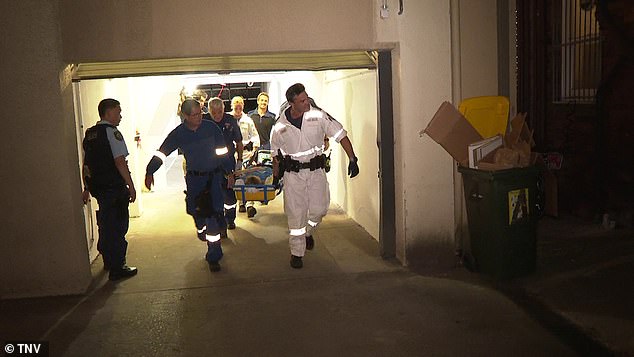 In the photo, emergency workers carry the injured woman on a stretcher