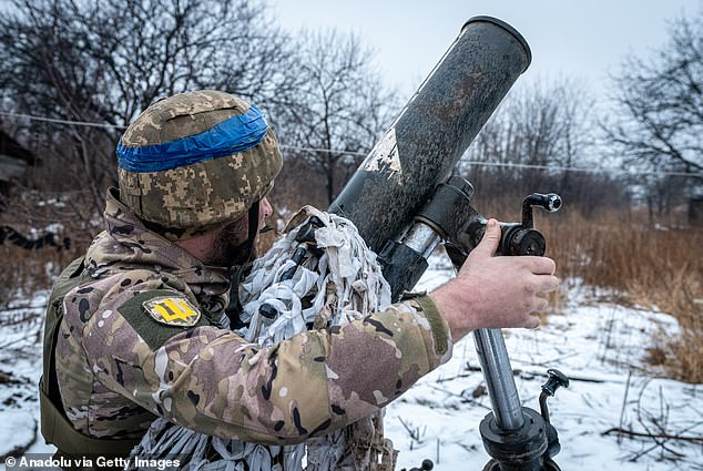 A Ukrainian soldier prepares a mortar before shooting a target in Bakhmut's direction