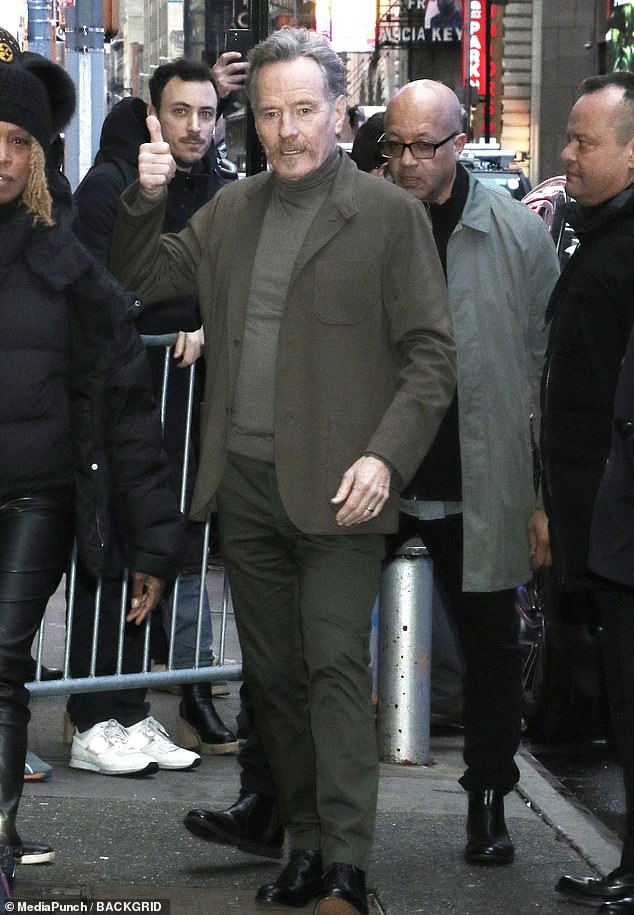 The Emmy winner stepped out in a brown turtleneck and jacket with sage green pants.  The veteran star swept his salt and pepper hair from his face and sported a handlebar mustache and soul patch