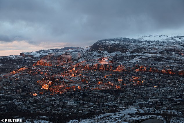 A view shows snow-covered trees and houses in Faraya, as seen from Kfardebian, Mount Lebanon