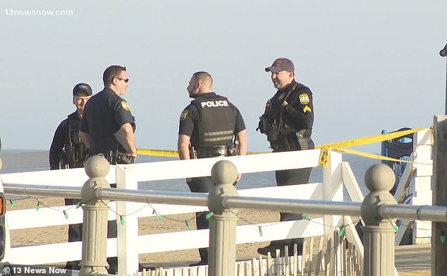 Virginia Beach Police are gathered at the pier as they conduct an investigation