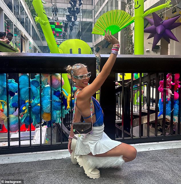 One of the night's DJs, Ruby J (pictured), went for a '90s raver look with furry white boots, space buns and reflective sunglasses