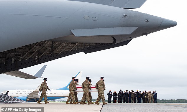 The coffins of thirteen American soldiers who died in Afghanistan are seen being carried to the tarmac