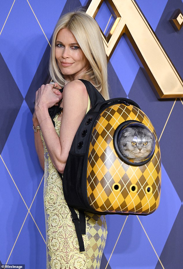 Claudia Schiffer wears a model of 'Chip the cat', a motif from the upcoming major film Argylle