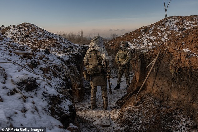 Ukrainian soldiers of the 41st Brigade stand in a trench near the front line, outside Kupiansk, Kharkiv region, on January 23, 2024