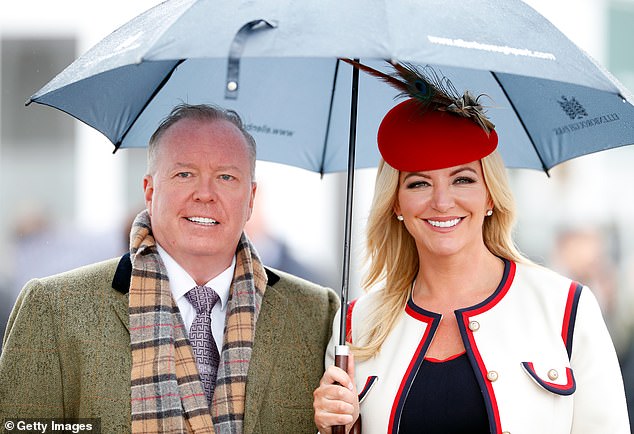 Doug Barrowman and his wife Baroness Michelle Mone, pictured here at Cheltenham Racecourse in March 2019, say they have been 'treated like a punching bag'