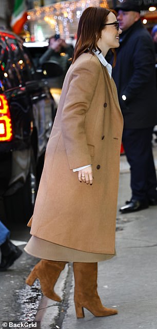 Emma (born Emily) dressed in a chic camel coat