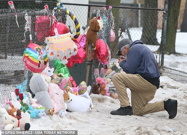 Community members left a memorial outside the blackened shell of the house and gathered for a balloon release on January 28