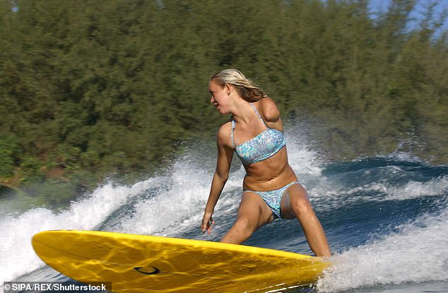 Bethany Hamilton, pictured at age 13 in 2004, was attacked by a shark while surfing near Tunnels Beach in Hawaii.  She lost her left arm just below her shoulder, but miraculously survived the attack