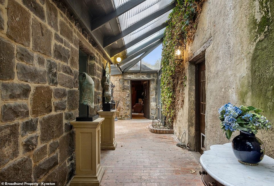 Upstairs there are two bedrooms and an ensuite bathroom and an extension is connected to the original house by a light-filled glass atrium