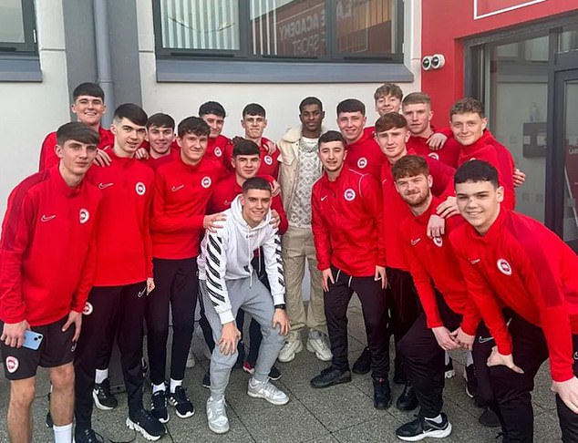 He posed for photos with some young players at Larne FC ahead of his boozy night out