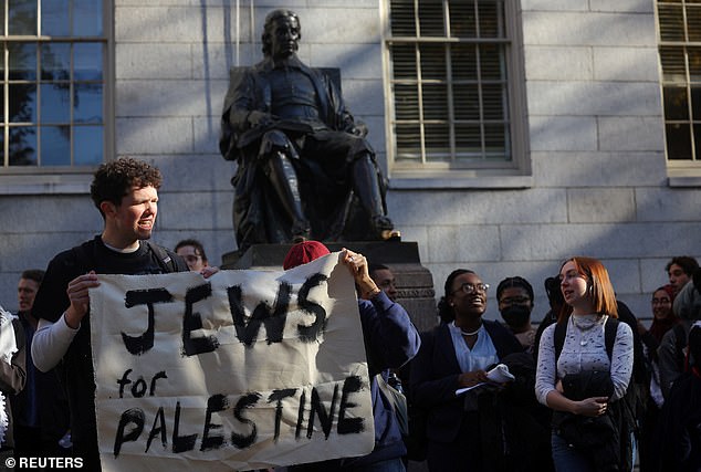 Protesters gather under statue of John Harvard in support of students participating in University Hall sit-in organized by a student collective called Harvard Jews for Palestine