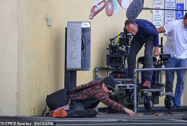 Cameras rolled as Leonardo dramatically stretched his hand across the sidewalk