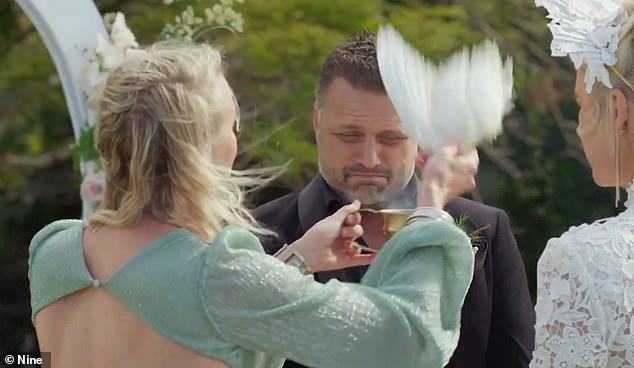Lucinda invited a celebrant to kick off their wedding with a smoking ceremony, waving a white-feathered 'chicken wing' in the air to 'cleanse away all the negativity'