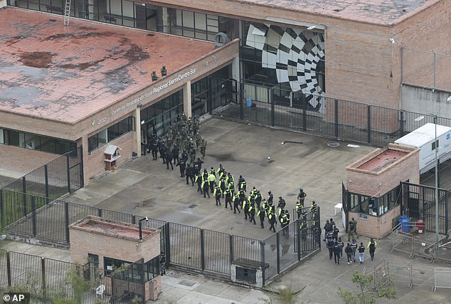 Soldiers enter the prison in Turi, Ecuador, on January 14.  The government is rolling out a plan to return more than 3,000 prisoners to their countries of origin in a bid to take control from powerful gangs