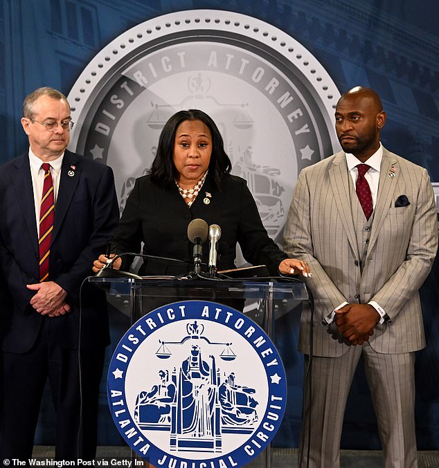 Willis is flanked by Wade on August 14 during a press conference to discuss the Trump case