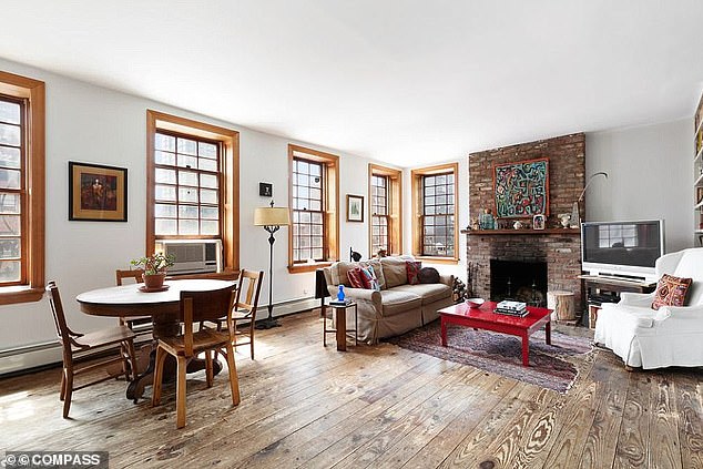 The 3,000-square-foot building is located at 72 East 1st Street.  The photo shows a spacious living room with a fixed dining area