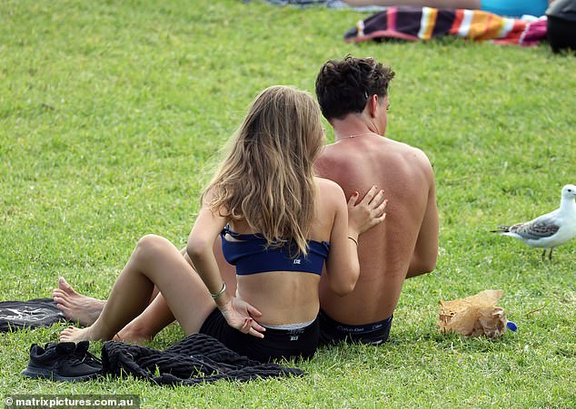 At one point, the couple looked in love as they sat down and rested on the grass, looking out to sea.