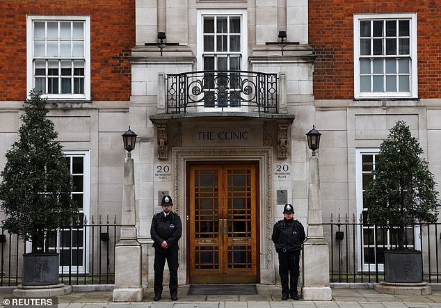Two police officers stand guard outside the London Clinic in Marylebone