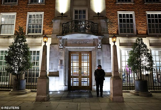 A police officer stands outside the London Clinic, where Catherine, Princess of Wales, was hospitalized for abdominal surgery