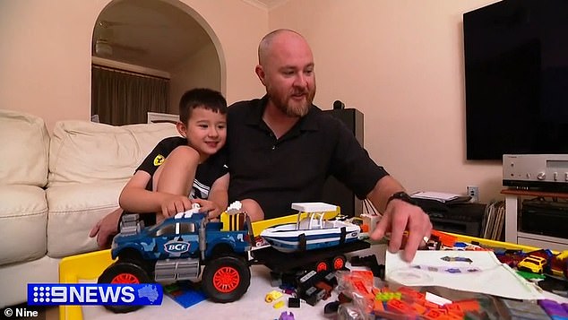 Daniel Shepherd (pictured with his son) was once an active youth worker but says he is now stuck in the heart of a 90-year-old after being forced to get a Covid shot to keep his job