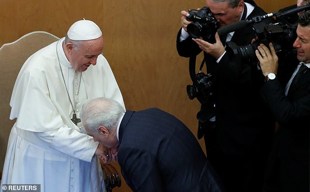 Film director Martin Scorsese kisses Pope Francis' hand as they participate in the presentation of the new book "Sharing the wisdom of the times" on the Pope's conversation with young people in Rome, Italy, October 23, 2018