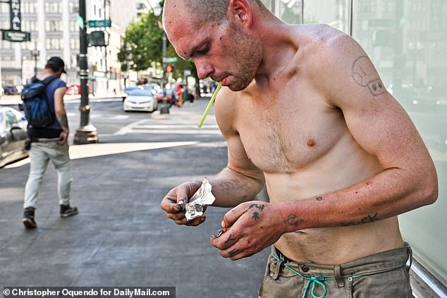 Oregon in 2020 became the first state in the country to decriminalize possession of all drugs, including heroin and cocaine.  Pictured is a man smoking crack in downtown Portland