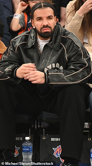 Drake (pictured at an NBA game in New York on January 27) will also have his songs removed