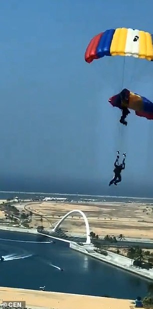 One of the paratroopers appears to be attached to another's harness