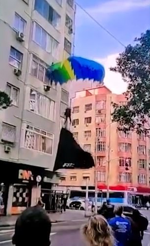 A paratrooper from the Brazilian army lands in the middle of the street in Rio de Janeiro