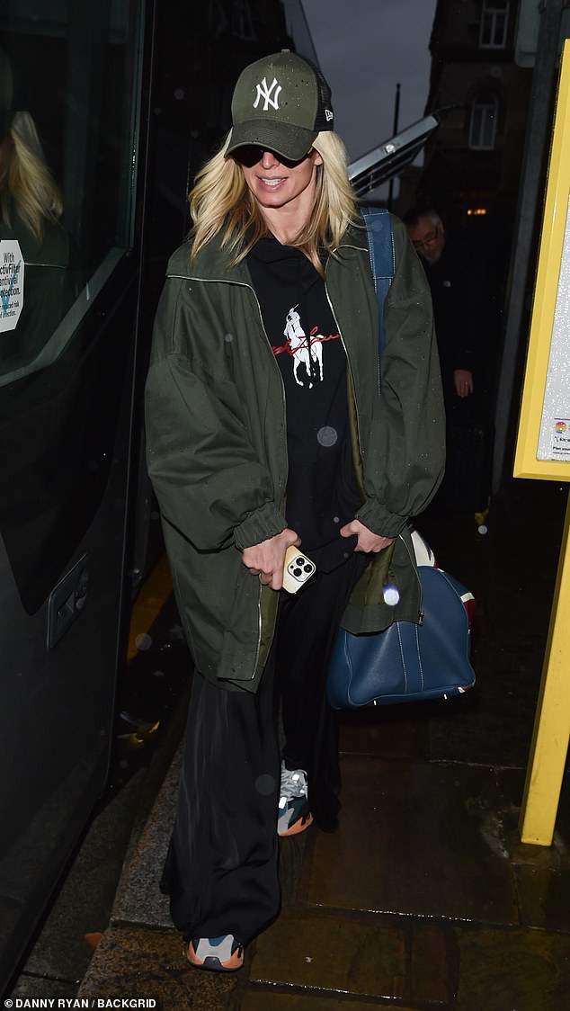 Nadiya Bychkova covered her face with a khaki cap while out and about