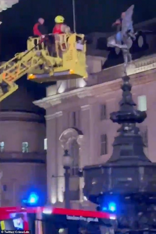 Bystanders were surprised to see a bald, bearded man in jeans and a gray jacket climbing the Eros statue in London