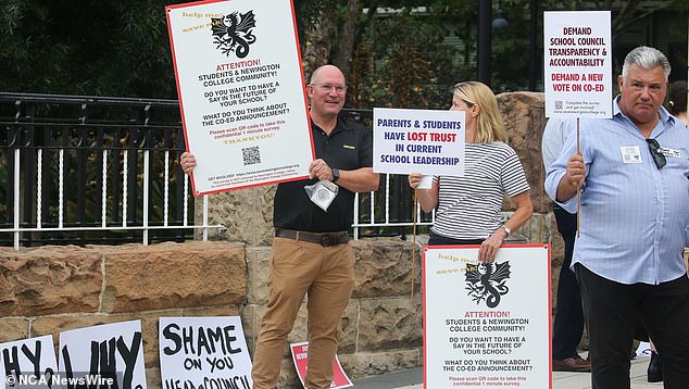 During the protest, demonstrators held up signs calling on the school to 