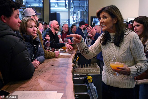 FILE PHOTO: Republican presidential candidate and former U.S. Ambassador to the United Nations Nikki Haley talks to people gathered at Deciduous Brewing ahead of the New Hampshire primary in Newmarket, New Hampshire, U.S., January 21, 2024. REUTERS/Brian Snyder/File Photo